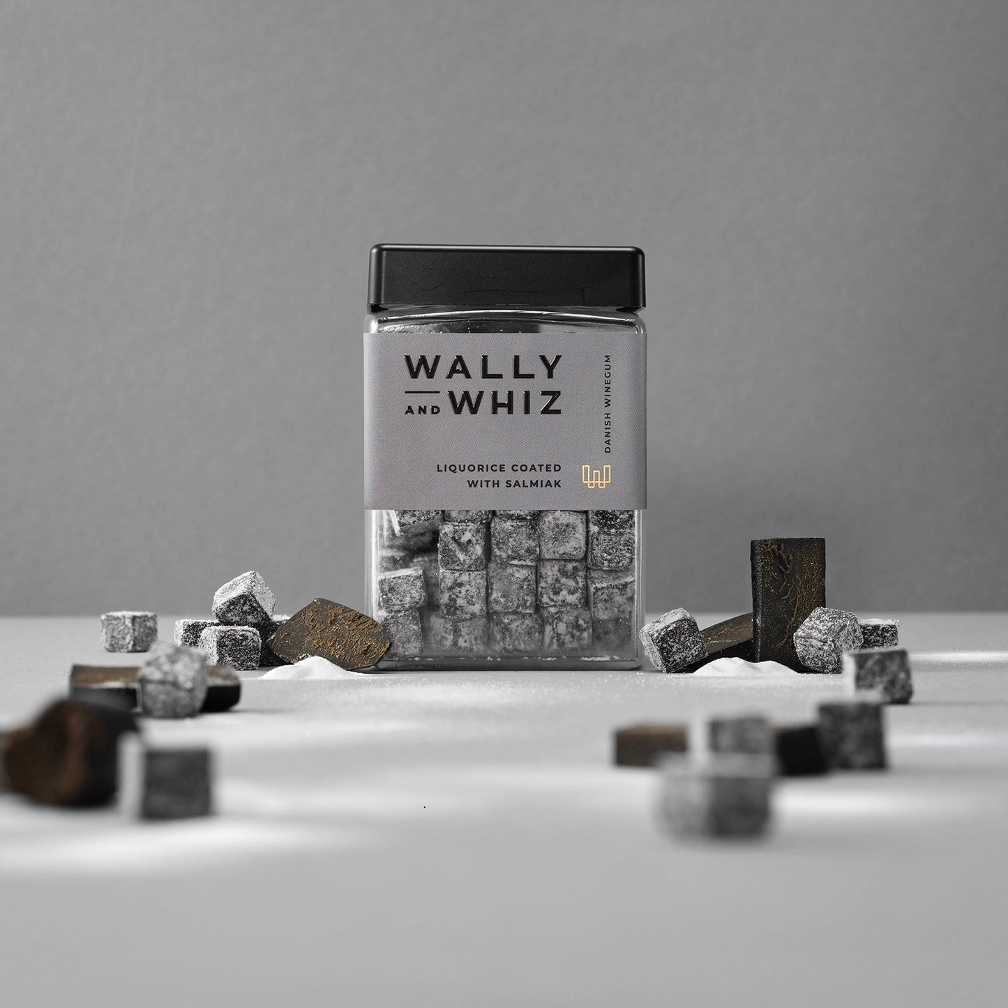 Wally and Whiz vegan/dairy free licorice with salmiak gummies in a jar on a gray background, gelatin free