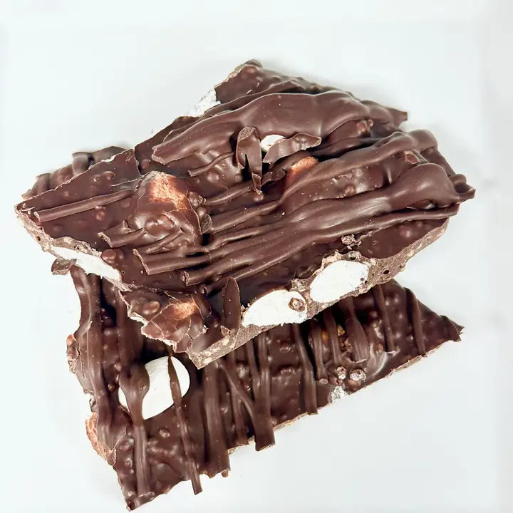 Stack of chocolate-covered treats on a white background